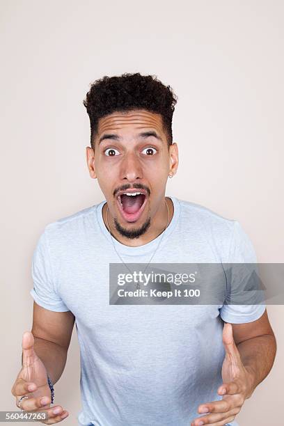 man with surprised expression - gesichtsausdruck stock-fotos und bilder
