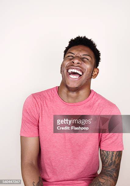 portrait of man laughing - black people laughing stock-fotos und bilder