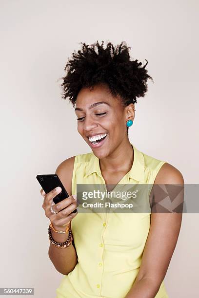 woman smiling using phone - smart phone white background stock-fotos und bilder