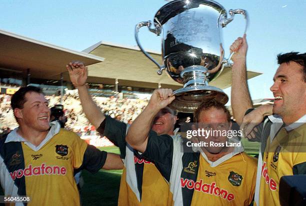 Victorious with the Bledisloe Cup are from left,Phil Kearns, Andrew Blades , Dan Crowley and Joe Roff following the Bledisloe clash against the All...