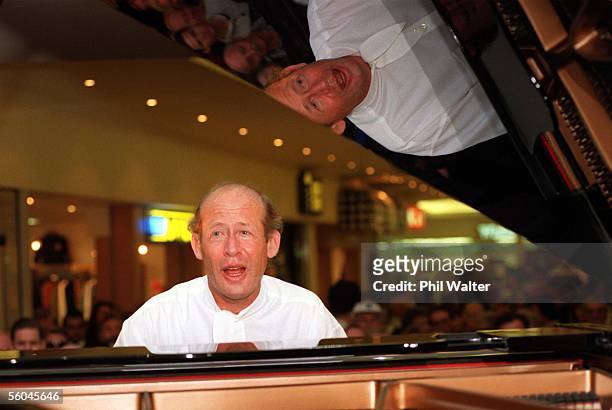 Piannist David Helfgott sings along as he entertains a crowd at Milford Plaza after performing a concert in Auckland last night. Helfgott afterwards...