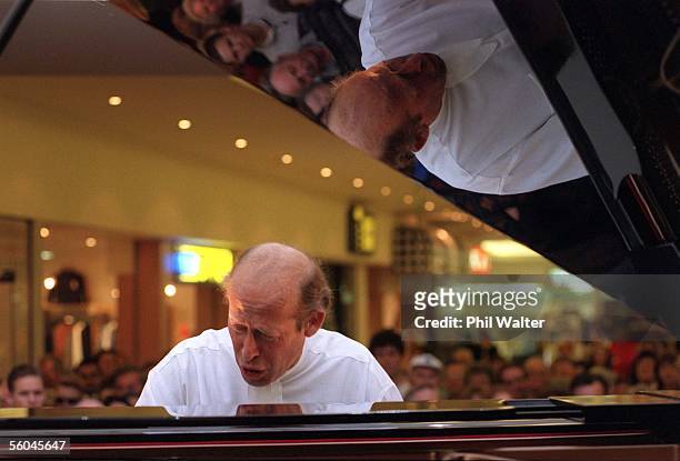 Piannist David Helfgott entertains a crowd at Milford Plaza after performing a concert in Auckland last night. Helfgott afterwards signed copies of...