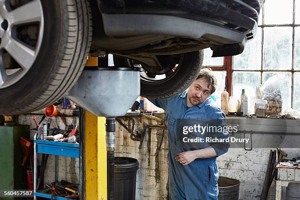 garage mechanic operating car lift - auto garage stock pictures, royalty-free photos & images