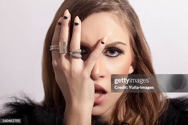stylish woman touching her face sensually - fingernagel stock-fotos und bilder