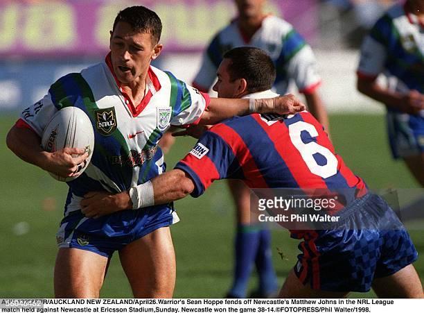 Warrior's Sean Hoppe fends off Newcastle's Matthew Johns in the NRL League rmatch held against Newcastle at Ericsson Stadium,Sunday. Newcastle won...