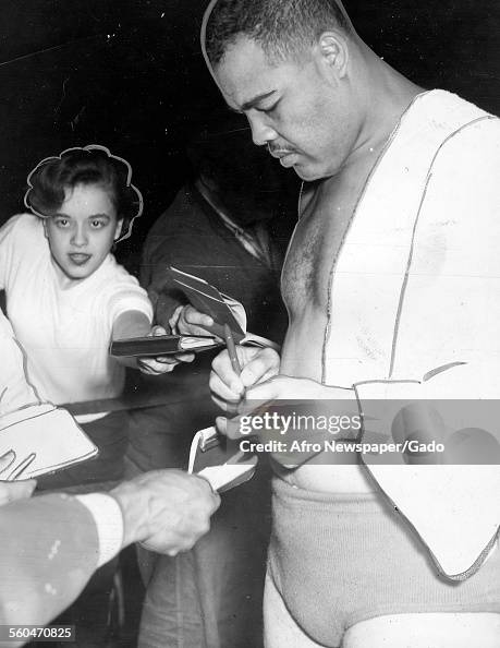 Joe Louis Signing Autographs Joe Louis Signing Autographs