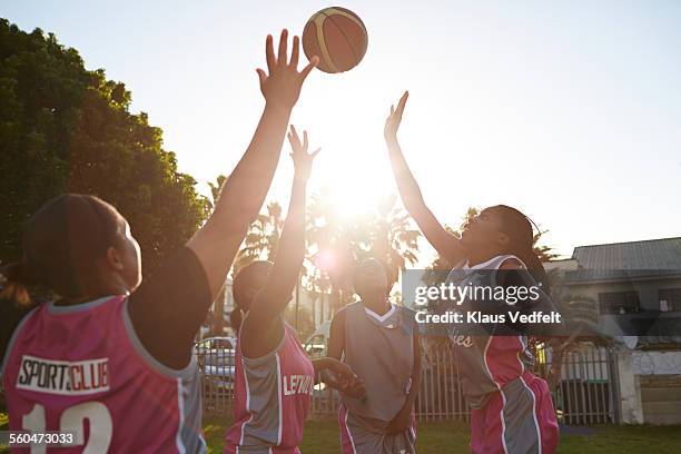female basket players jumping to get the ball - female basketball team stock pictures, royalty-free photos & images