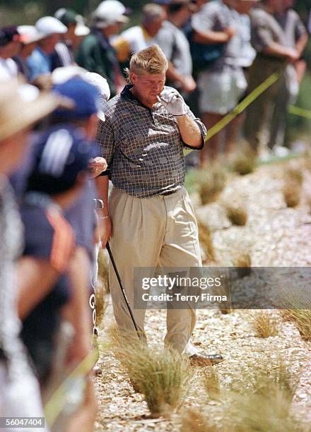 Big John Daly takes a puff on the obligatory fag as he waits on to hit out of the rough, on day two of the World Cup Of Golf, played at the Gulf...