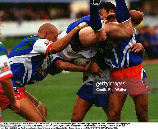 Auckland Warriors Tyran Smith and Nigel Vagana upend a Canterbury Bulldogs player in the trial series rugby league match held at QE2 Stadium,...