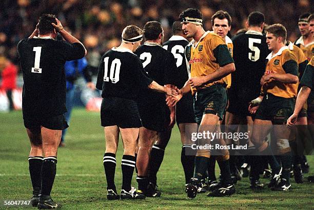 The body language says it all as Craig Dowd clutches his head and Andrew Mehrtens shakes hands with Wallaby captain John Eales, after the Wallabies...