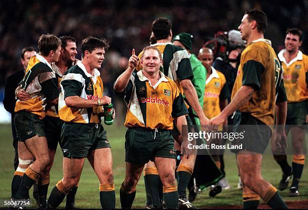 Wallaby prop Dan Crowley signals to the crowd, as his teamates Ben Tune, David Wilson, Mathew Burke and Mark Cockbain share their joy, after their...