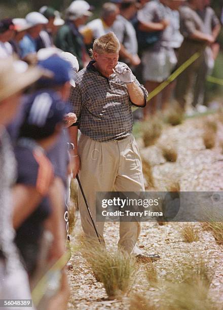 Big John Daly takes a puff on the obligatory fag as he waits on to hit out of the rough, on day two of the World Cup Of Golf, played at the Gulf...