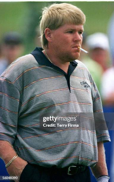 Big John Daly takes a puff on the obligatory fag as he waits on the tee on the second day of the World Cup of Golf, Gulf Harbour Country Club,...