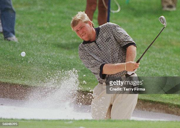 Big John Daly chips out of thee bunker on the 6th, on day two of the World Cup Of Golf, played at the Gulf Harbour Country Club, Whangaparaoa.