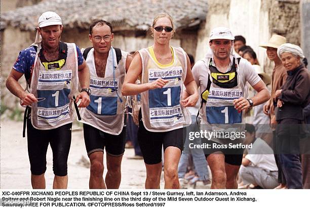 Steve Gurney, left, Ian Adamson, Andrea Spitzer and Robert Nagle near the finishing line on the third day of the Mild Seven Outdoor Quest in Xichang,...