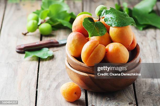 fresh sweet apricots on the wooden table - albaricoque fotografías e imágenes de stock