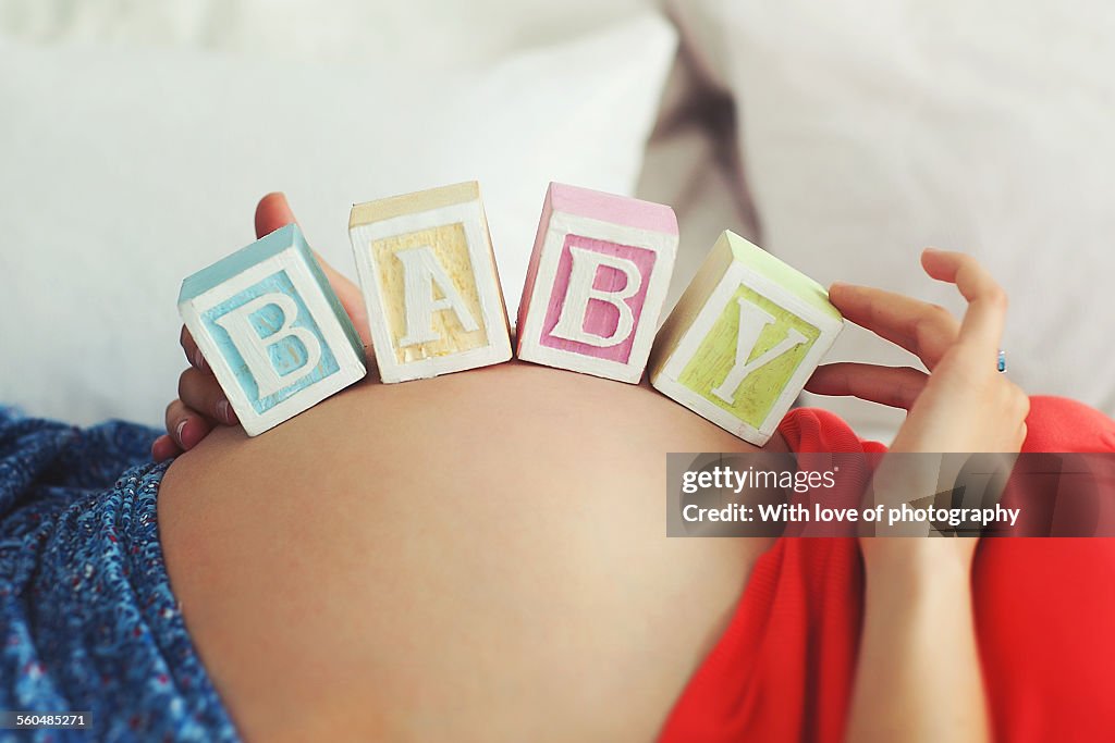 Baby bump with toy blocks BABY