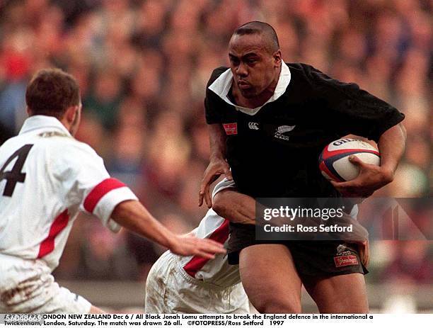 All Black Jonah Lomu attempts to break the England defence in the international a Twickenham, London, Saturday. The match was drawn 26 all.