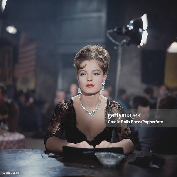 Austrian born actress Romy Schneider pictured wearing a black lace dress on the set of a film in 1965.