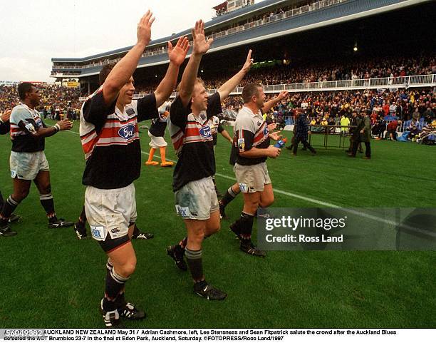 Adrian Cashmore, left, Lee Stensness and Sean Fitpatrick salute the crowd after the Auckland Blues defeated the ACT Brumbies 237 in the final at Eden...