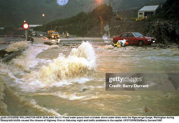Flood water pours from a broken storm water drain onto the Ngauranga Gorge, Wellington during heavy rain which caused the closure of Highway One on...