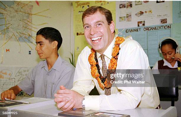 Prince Andrew laugh's as he sits in on a Japanese and French language class taught in the same classroom together at the Tonga High School during his...