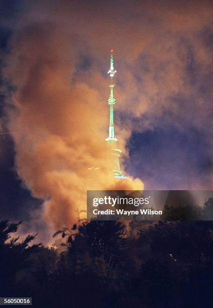 Flames from a scrub fire in Bersford St,Freemans Bay frame Auckland's Sky Tower on New Years Eve.The fire was started by a stray fire cracker from...