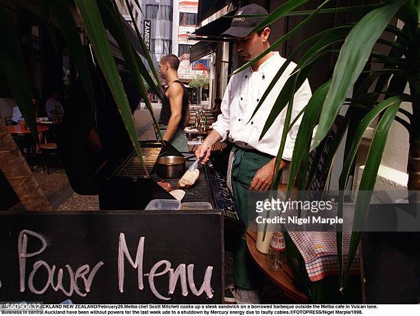 Melba chef Scott Mitchell cooks up a steak sandwich on a borrowed barbeque outside the Melba cafe in Vulcan lane.rBuisness in central Auckland have...