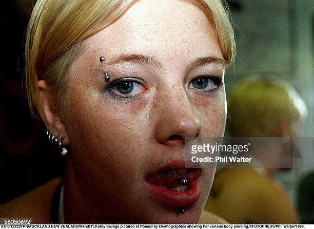 Katey Savage pictured at Ponsonby Dermographics showing her various body piercing.