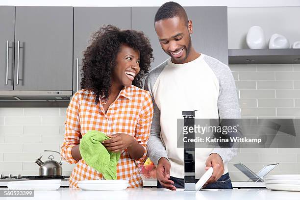 man and woman washing dishes. - wash the dishes stock pictures, royalty-free photos & images