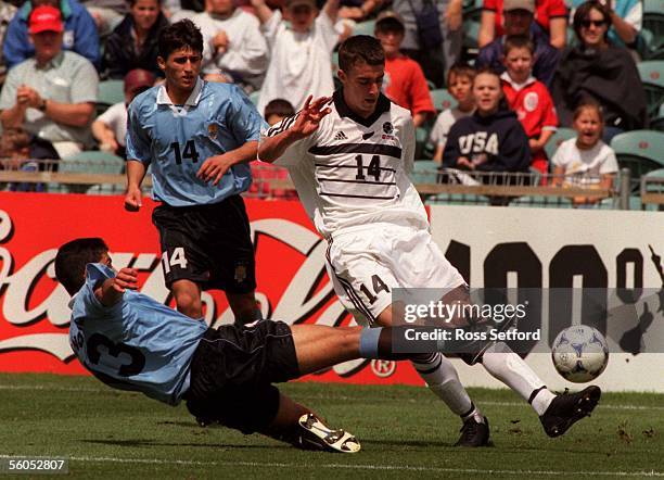 New Zealand's Neil Jones slips around Uruguay's Gonzalo Novegil in the FIFA under 17 World Championship at North Harbour Stadium, Albany, Saturday....