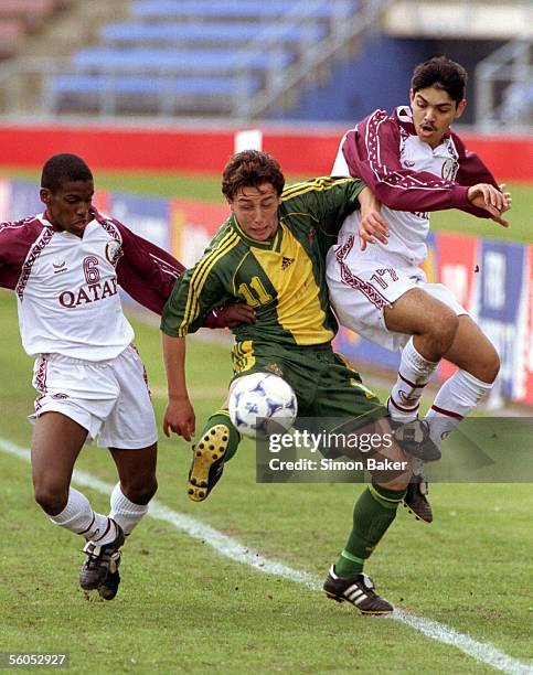 Australia's Scott McDonald, centre, tries to the break the defences of Qatar's Meshal,left,and Bilal during their quarter final soccer match in the...