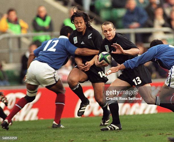 All Black Christian Cullen fends against France in the semi final of the Rugby World Cup at Twickenham, London, Sunday.