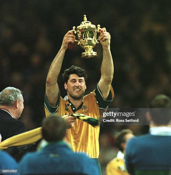 Wallaby captain John Eales holds aloft the Rugby World Cup after they defeated France in the final 3512 at the Millennium Stadium, Cardiff, Saturday.