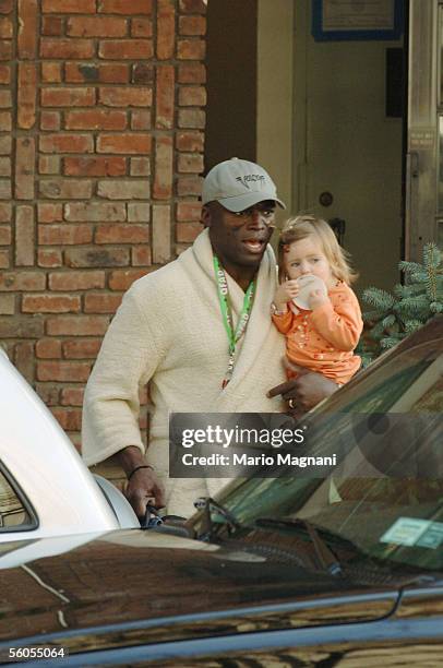 Singer Seal, husband of supermodel Heidi Klum, exits their residence in his bathrobe with her child, Leni on November 1, 2005 in New York City.