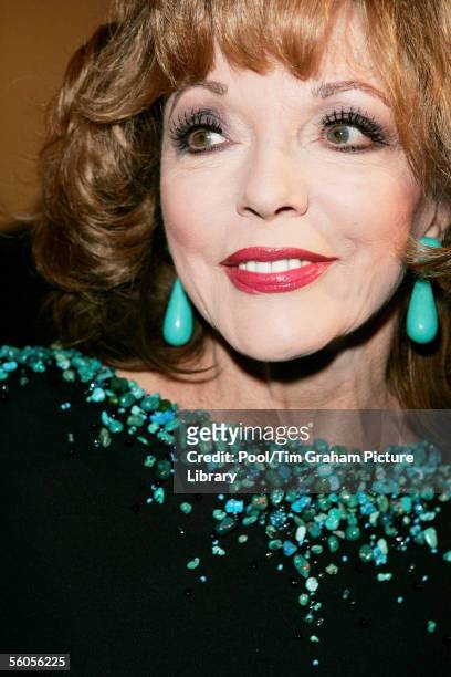 Movie actor Joan Collins attends a reception with Prince Charles, Prince of Wales and Camilla, Duchess of Cornwall at the Museum of Modern Art on...