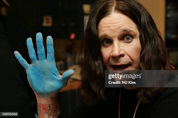 Ozzy Osbourne adds his blue handprint to the official book as he films the video for the new Tsunami relief charity single, a cover of the Sir Eric...