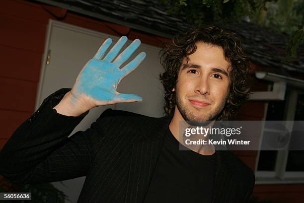 Josh Groban takes a break to make his handprint in the official book during the recording of his contribution to the new disaster relief charity...