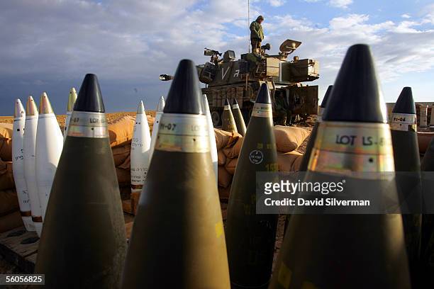 Israeli army soldiers wake up alongside their 155mm mobile artillery cannon after a night of action against Palestinian militants in the northern...