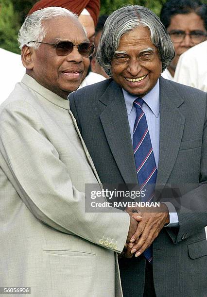 In this picture taken 24 July 2002, Outgoing Indian President K.R. Narayanan greets newly elected President A.P.J. Abdul Kalam during a ceremony at...