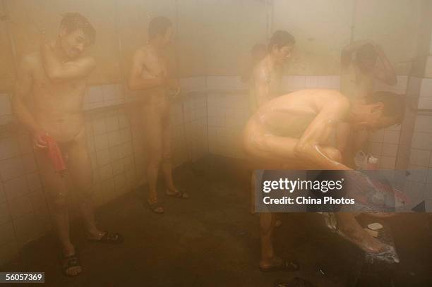 Workers bath in a coal briquette factory after work on October 31, 2005 in Beijing, China. Coal supplies 70 percent of the energy needs of China's...