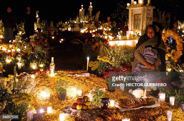 Woman mourns beside a relative's grave in the cementery of Tzinzunzan, Michoacan, 02 November 2005 during the Day of the Dead in Mexico. AFP PHOTO /...