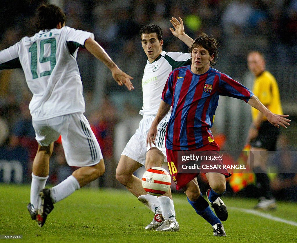 Barcelona's Lionel Messi (R) vies with P