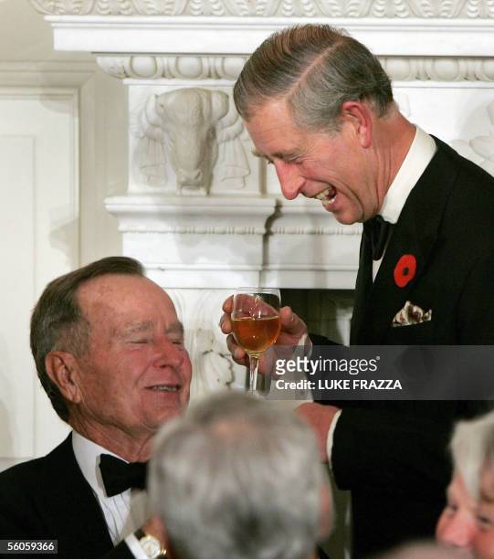 Washington, UNITED STATES: The Prince of Wales jokes with former US president George H. W. Bush after the Prince offered a toast to US President...