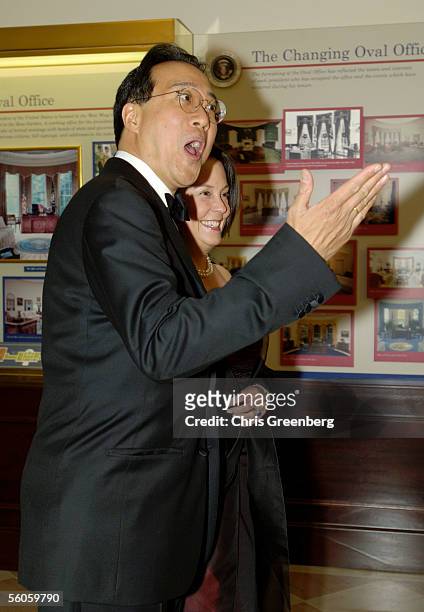 Cellist Yo-Yo Ma and Jill Hornor react to a reporter's question as they walk through the Booksellers room of the White House en route to a social...