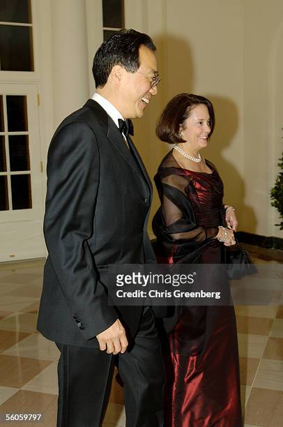Cellist Yo-Yo Ma and Jill Hornor react to a reporter's question as they walk through the Booksellers room of the White House en route to a social...