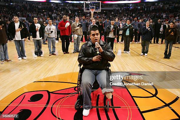 Sal Gonzalez, a U.S. Marine wounded in Iraq, joins other wounded soldiers as he sings the national anthem before the season-opening game between the...