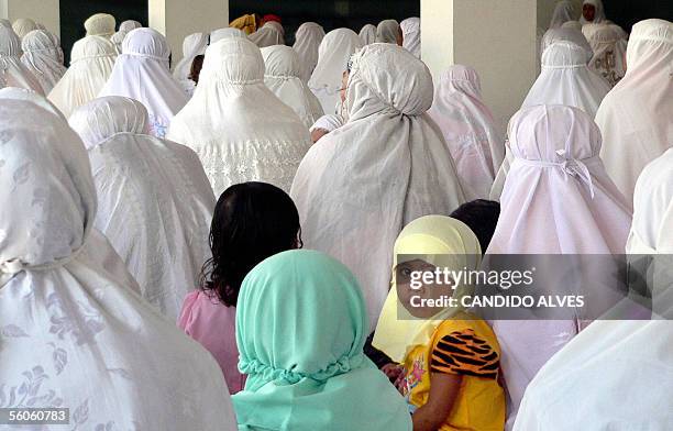 Child looks on as she stands among Muslim women attending Eid Al-Fitr prayers in Dili, 03 November 2005. Muslims consider Eid-al Fitr, which falls at...