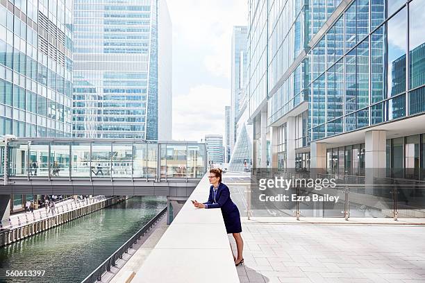 experienced businesswoman with smartphone in city - water plant stock-fotos und bilder