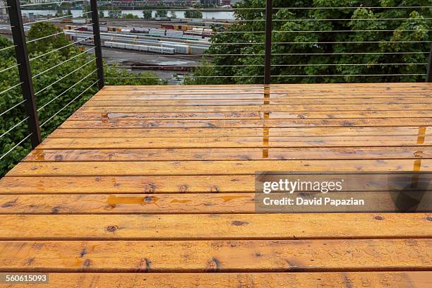 new wooden deck after rain storm - wooden railing stock pictures, royalty-free photos & images